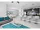 Open-concept kitchen with dark cabinets, a breakfast bar and adjoining dining area at 1578 Slice Way, Davenport, FL 33896