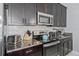 Close-up of modern kitchen with stainless steel appliances, granite countertops, and stylish backsplash at 1578 Slice Way, Davenport, FL 33896