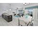 Open-concept space with dining area, large windows, and sliding glass doors to outdoor patio at 1578 Slice Way, Davenport, FL 33896