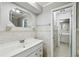 Clean bathroom featuring a large mirror and white vanity with detailed tiling at 16 Pine Forest Dr, Haines City, FL 33844