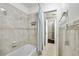 Bright bathroom featuring tiled walls and bathtub with shower at 16 Pine Forest Dr, Haines City, FL 33844