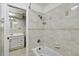 Bathroom featuring a tub/shower and neutral tile, leading to vanity at 16 Pine Forest Dr, Haines City, FL 33844