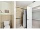 Cozy bathroom with a shower stall, toilet, and decorative wall accent at 16 Pine Forest Dr, Haines City, FL 33844