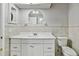 Bright bathroom showcasing a white vanity, mirror, and toilet for convenience at 16 Pine Forest Dr, Haines City, FL 33844