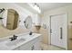 Bathroom featuring dual sinks, cabinet, and an overhead light fixture at 16 Pine Forest Dr, Haines City, FL 33844
