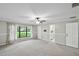 A spacious bedroom featuring a ceiling fan, large window, and neutral color palette creates a relaxing atmosphere at 16 Pine Forest Dr, Haines City, FL 33844