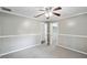 Neutral bedroom featuring neutral carpet, a ceiling fan, and closet access at 16 Pine Forest Dr, Haines City, FL 33844
