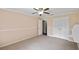 Spacious bedroom offers a ceiling fan, neutral carpeting, an ensuite bathroom, and a walk-in closet at 16 Pine Forest Dr, Haines City, FL 33844