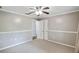Neutral bedroom featuring neutral carpet, a ceiling fan, and closet access at 16 Pine Forest Dr, Haines City, FL 33844