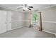Bright bedroom featuring neutral carpet, a ceiling fan, and a large window at 16 Pine Forest Dr, Haines City, FL 33844