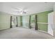 Expansive bedroom showcases a ceiling fan, neutral carpeting, a closet, and ample natural light at 16 Pine Forest Dr, Haines City, FL 33844