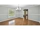 Bright dining area with large window and modern chandelier at 16 Pine Forest Dr, Haines City, FL 33844