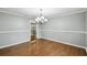 Dining room with modern chandelier, neutral paint, and view to adjoining room at 16 Pine Forest Dr, Haines City, FL 33844