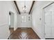 Lovely entryway featuring brick flooring, a chandelier, and a sidelight front door at 16 Pine Forest Dr, Haines City, FL 33844