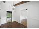 Spacious entryway featuring brick flooring, wood beams, a chandelier, and views of multiple rooms at 16 Pine Forest Dr, Haines City, FL 33844