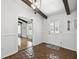 Entryway with brick flooring, wood beams, a chandelier, and views of multiple rooms at 16 Pine Forest Dr, Haines City, FL 33844