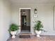Open view of the entryway with brick flooring, chandelier, and a partial view of the interior at 16 Pine Forest Dr, Haines City, FL 33844