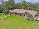 Overhead shot of a well-maintained home with a large lawn and mature trees creating a serene setting at 16 Pine Forest Dr, Haines City, FL 33844