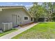 Gray home exterior with a well-manicured lawn and mature trees at 16 Pine Forest Dr, Haines City, FL 33844