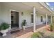 Inviting front porch with brick flooring, potted plants, and a partial view of the entry at 16 Pine Forest Dr, Haines City, FL 33844