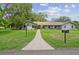 Charming single story home with a well manicured lawn and inviting walkway to the front door at 16 Pine Forest Dr, Haines City, FL 33844