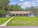 Beautiful single story home with large front lawn, mailbox, and inviting walkway to the front door at 16 Pine Forest Dr, Haines City, FL 33844