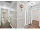 Inviting hallway with hardwood floors, decorative lighting, and traditional trim at 16 Pine Forest Dr, Haines City, FL 33844