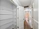 Hallway closet with white shelving adds convenient storage space and complements the home's interior design at 16 Pine Forest Dr, Haines City, FL 33844