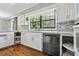 Modern kitchen featuring stainless steel appliances, white cabinets, backsplash, and hardwood floors throughout at 16 Pine Forest Dr, Haines City, FL 33844