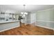 Eat-in kitchen featuring wood floors, breakfast bar, stainless appliances, and an adjacent dining area for seamless entertaining at 16 Pine Forest Dr, Haines City, FL 33844