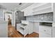Bright kitchen features white cabinets, subway tile backsplash, stainless steel appliances, and hardwood floors at 16 Pine Forest Dr, Haines City, FL 33844