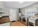 Laundry room with washer, dryer, sink, and counter space offers convenience and functionality for everyday tasks at 16 Pine Forest Dr, Haines City, FL 33844