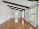 Spacious living room with ceiling beams, wood floors, and large windows provides ample natural light at 16 Pine Forest Dr, Haines City, FL 33844