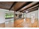 Inviting living room with stone fireplace, wood beam ceiling, and access to outdoors at 16 Pine Forest Dr, Haines City, FL 33844