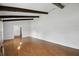Bright living room with wood floors, ceiling beams, and an open floor plan offers a welcoming space at 16 Pine Forest Dr, Haines City, FL 33844