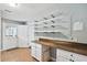 Bright mud room with shelves, cabinets, countertop, tile floors, and exterior access at 16 Pine Forest Dr, Haines City, FL 33844