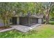 View of the covered screened patio offering private outdoor living space at 16 Pine Forest Dr, Haines City, FL 33844