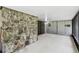 Spacious screened porch with stone accents and a peaceful backyard view at 16 Pine Forest Dr, Haines City, FL 33844