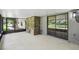 Relaxing screened porch with stone accent wall and view of yard at 16 Pine Forest Dr, Haines City, FL 33844