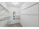 Walk-in closet with white wire shelving, carpet, and a mirror for added convenience at 16 Pine Forest Dr, Haines City, FL 33844