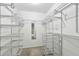 Organized walk-in closet with ample shelving and storage solutions, complete with mirror, for efficient storage at 16 Pine Forest Dr, Haines City, FL 33844