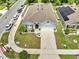 Overhead shot of a single-story home with a two-car garage and lush landscaping, and street parking at 1600 Spray Ter, St Cloud, FL 34771