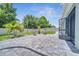 Paver patio and backyard with privacy fence, two chairs and decorative lighting at 1600 Spray Ter, St Cloud, FL 34771