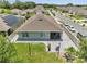 An aerial view of a backyard with a stone patio, a small lawn, and a privacy fence at 1600 Spray Ter, St Cloud, FL 34771
