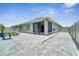 Exterior view of home with a paver patio, outdoor seating, and decorative string lights at 1600 Spray Ter, St Cloud, FL 34771