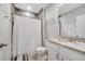 Clean bathroom with a granite vanity, white cabinets, tile flooring, neutral walls, and tiled shower at 1600 Spray Ter, St Cloud, FL 34771