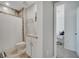 Clean bathroom with a shower, granite vanity, white cabinets, tile flooring, and neutral walls at 1600 Spray Ter, St Cloud, FL 34771