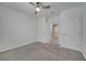 Bright bedroom with plush carpet, ceiling fan and easy access to the main hallway at 1600 Spray Ter, St Cloud, FL 34771