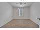 Cozy bedroom with neutral carpet, ceiling fan, and a window for natural light at 1600 Spray Ter, St Cloud, FL 34771