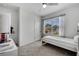 Cozy bedroom with a fan, neutral walls, carpet flooring, and a bright window with patterned curtains at 1600 Spray Ter, St Cloud, FL 34771